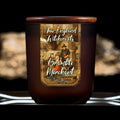 Image depicts a frosted amber candle jar with lid and a label depicting an oil painting of a merchant arriving in town surrounded by curious children.