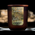 Image depicts a frosted amber candle jar with lid and a label depicting an oil painting of faeries basking in a grotto.