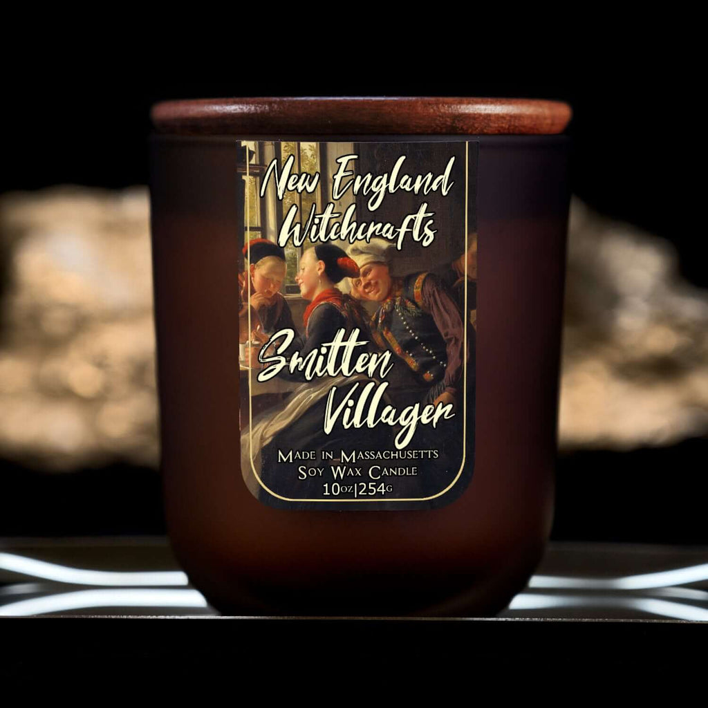 Image depicts a frosted amber candle jar with lid and a label depicting an oil painting of a lovestruck man.