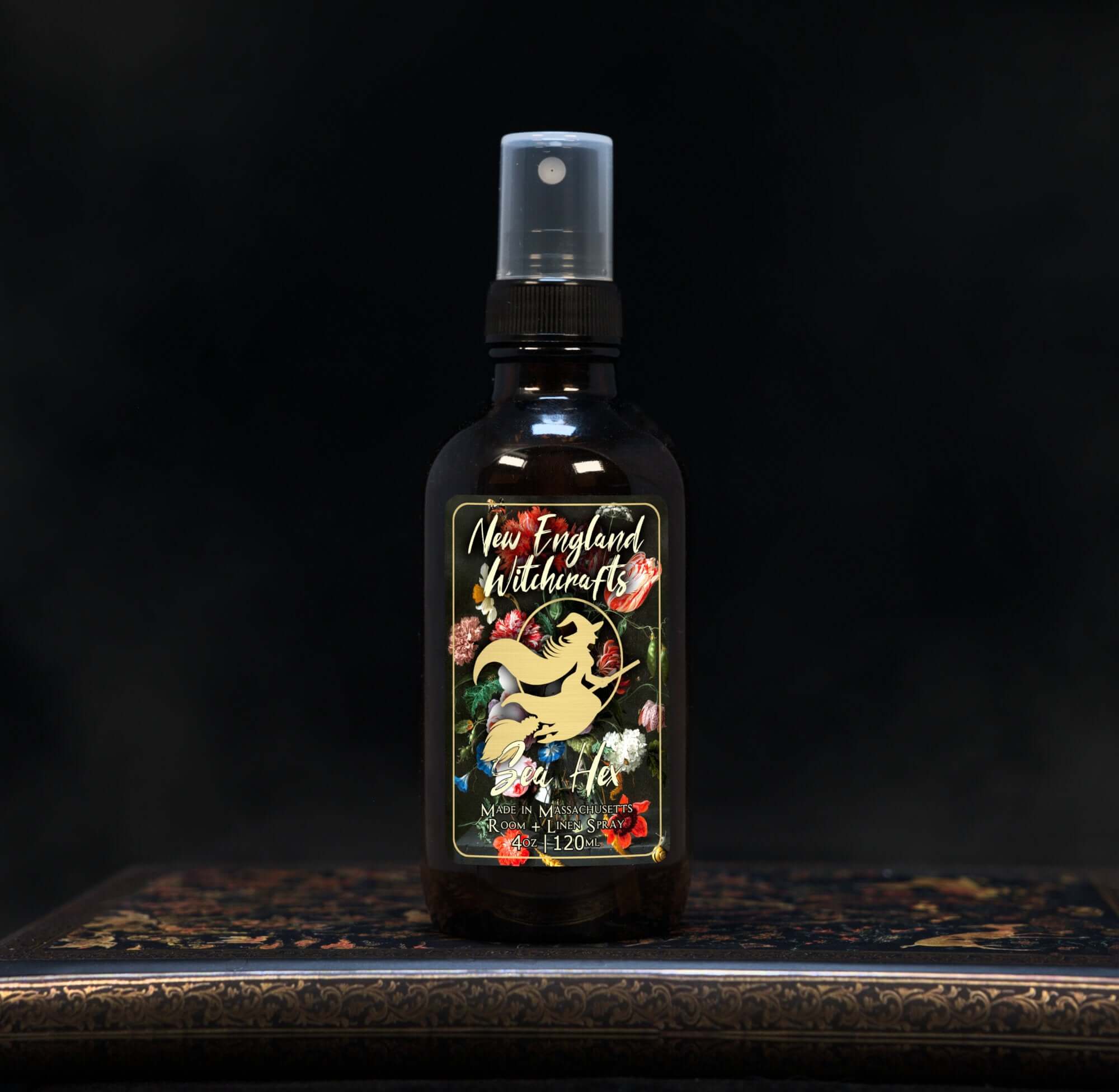 Image depicts a room spray bottle with floral print label.